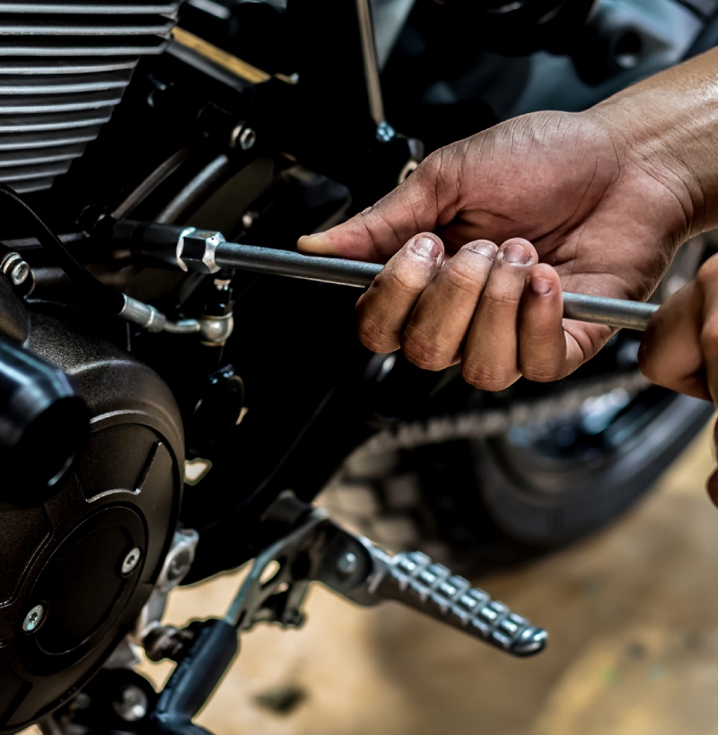 motorcycle engine repair with wrench